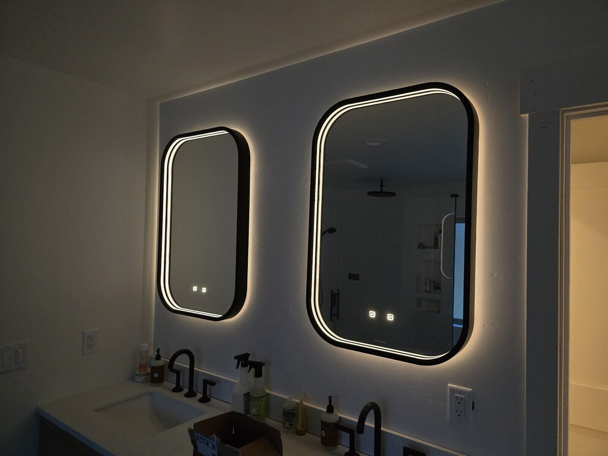 Modern bathroom renovation with dual illuminated mirrors above a sleek vanity in Sacramento, CA, by H&H Builds